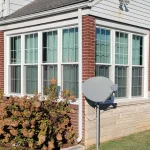 Double-hung windows with colonial grids on red brick house in Tell City, IN